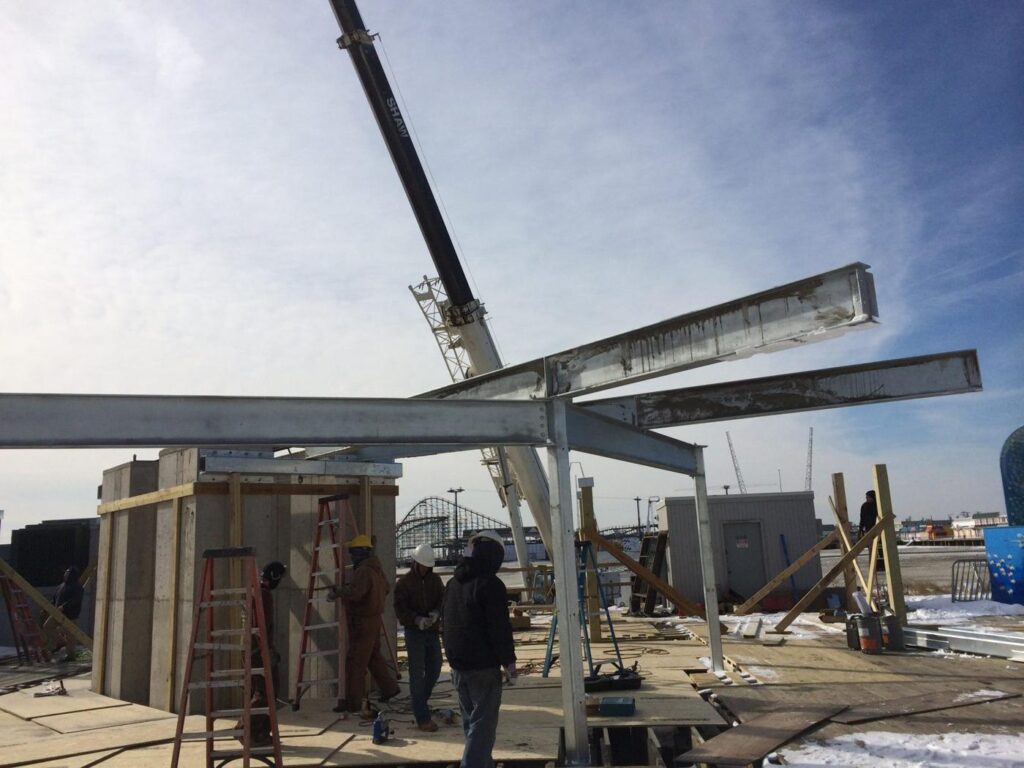 Crane lifting galvanized steel on the boardwalk