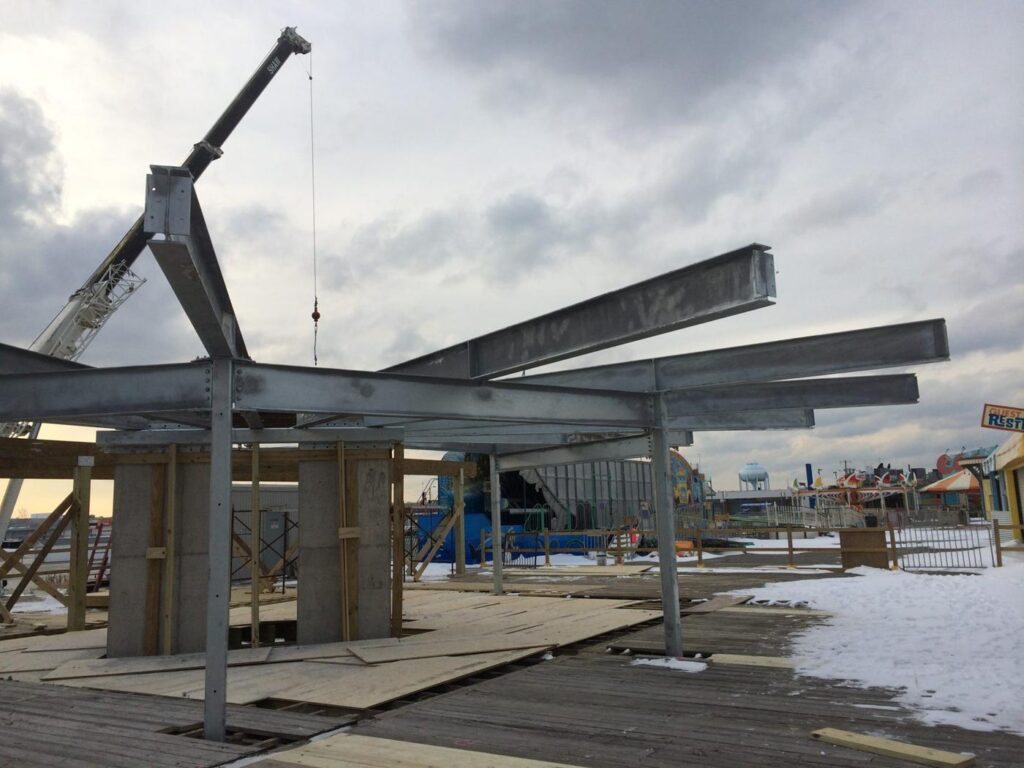 Crane lifting galvanized steel on the boardwalk
