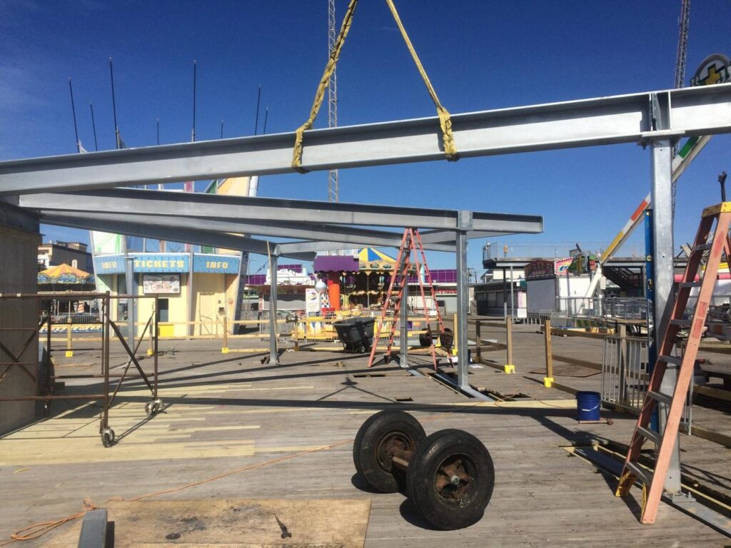 Crane lifting galvanized steel on the boardwalk