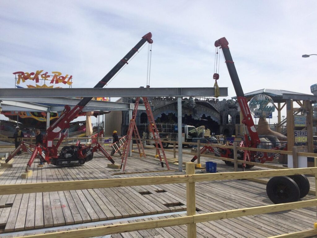 Crane lifting galvanized steel on the boardwalk