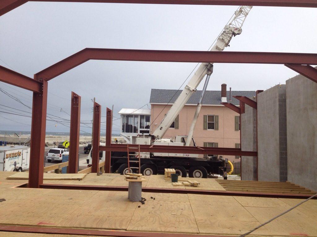 Crane lifting galvanized steel on the boardwalk