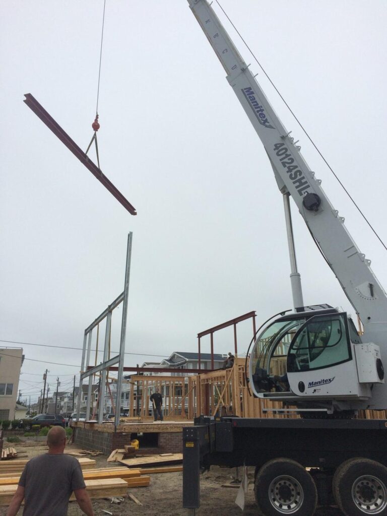 Boom truck crane setting steel on a residential job