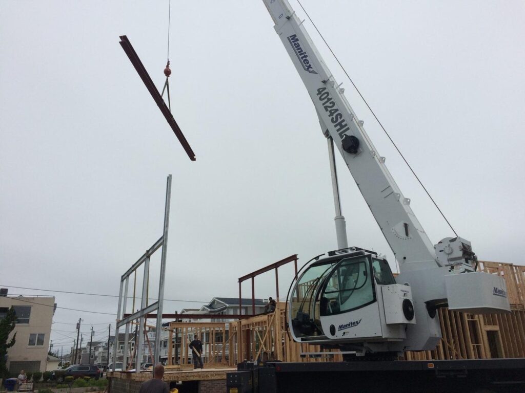 Boom truck crane setting steel on a residential job