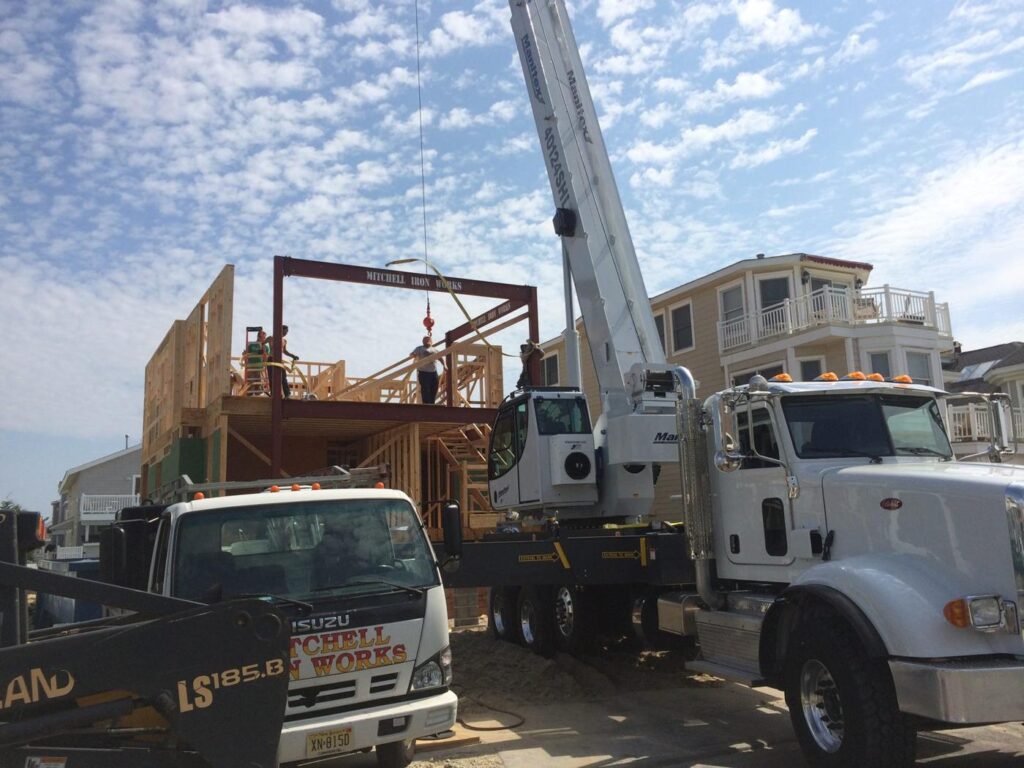 Boom truck crane setting steel on a residential job