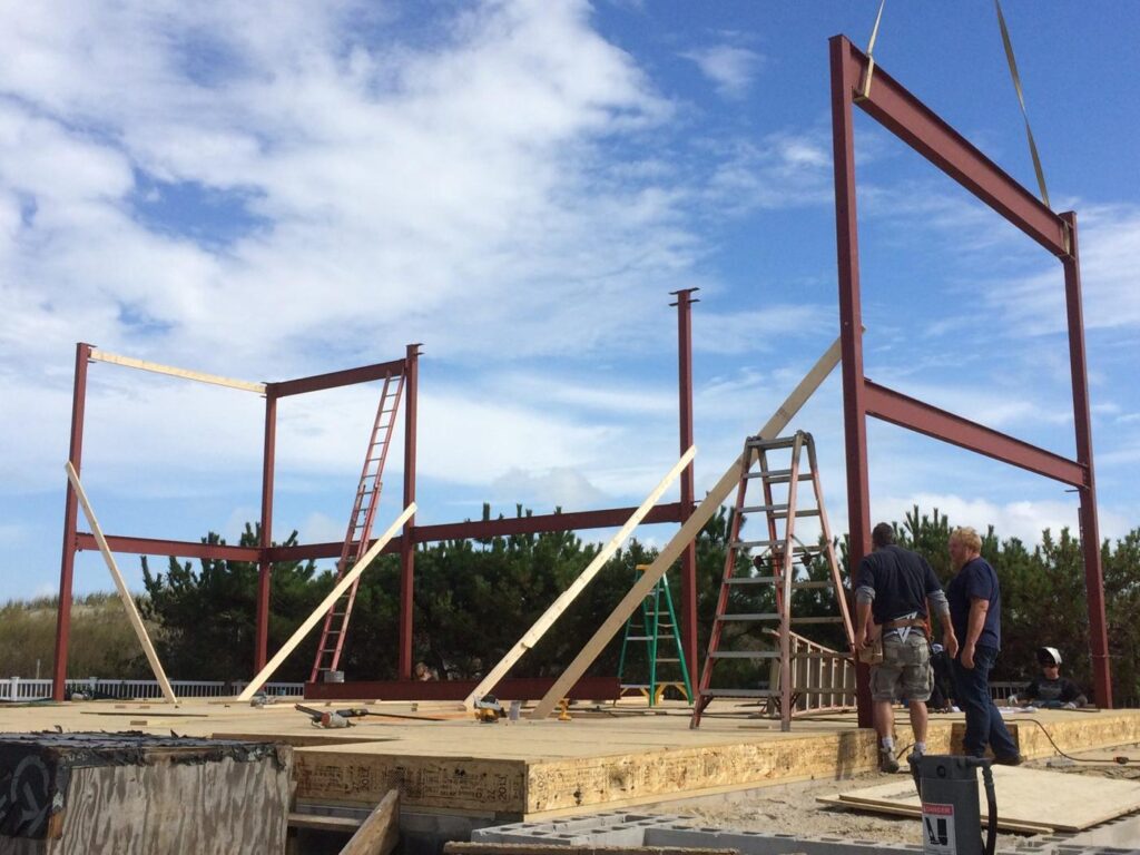 Crane setting a steel frame on a new shore home