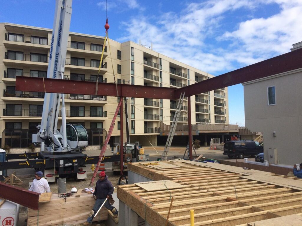 Crane setting a steel frame on a new shore home