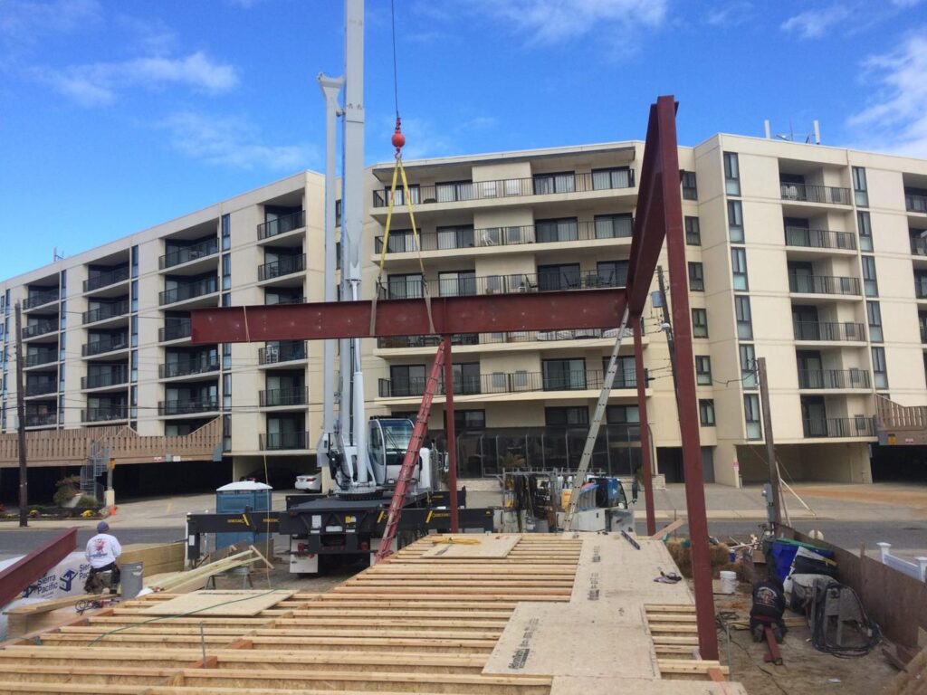 Crane setting a steel frame on a new shore home