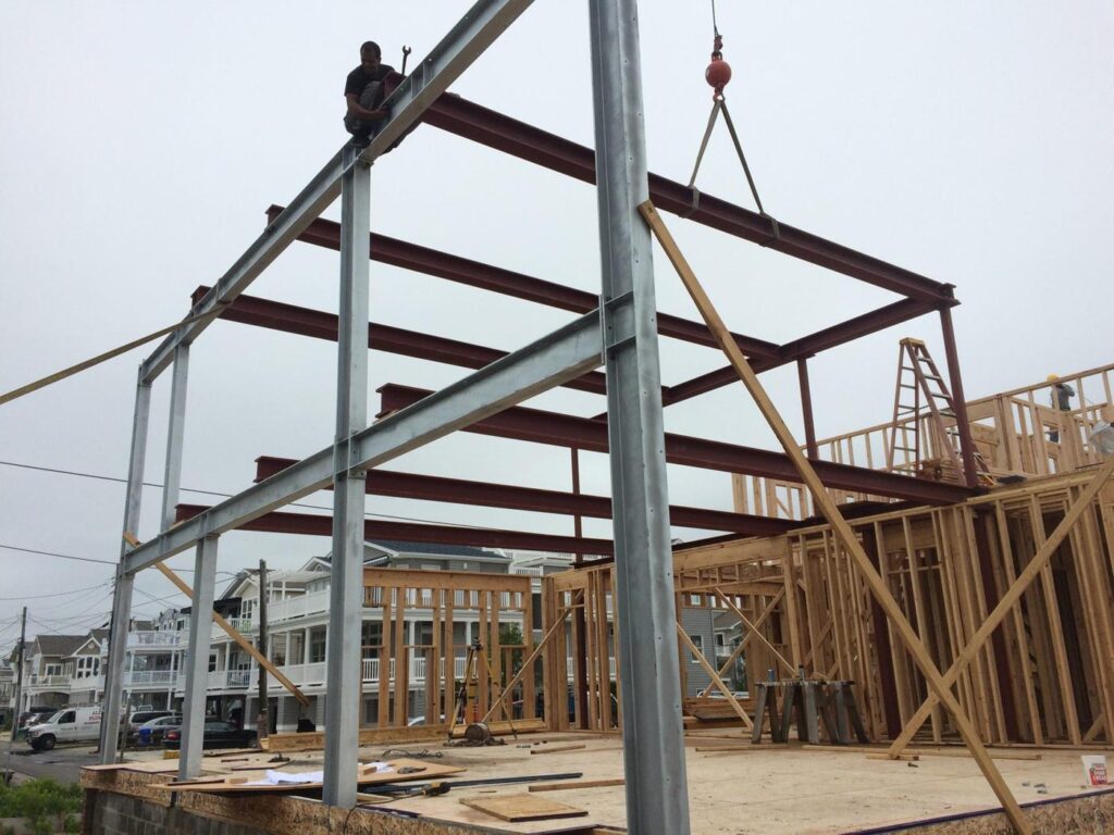 Crane setting a steel frame on a new shore home