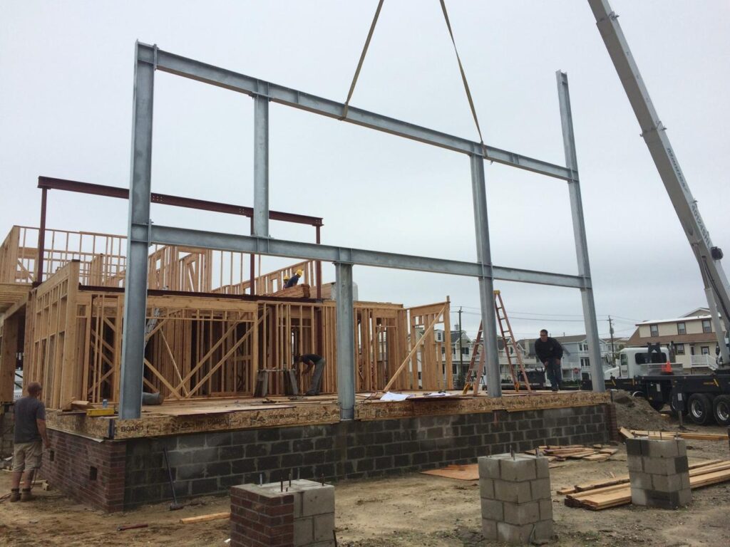 Crane setting a steel frame on a new shore home