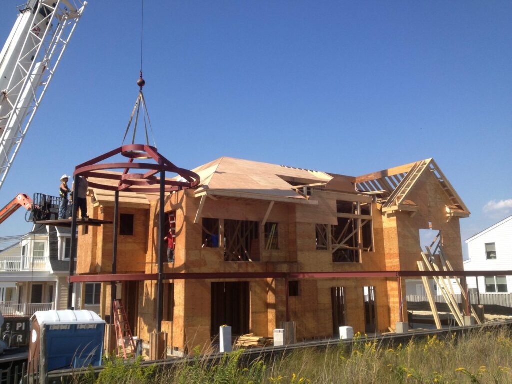 Round steel turret frame lifted into place by crane