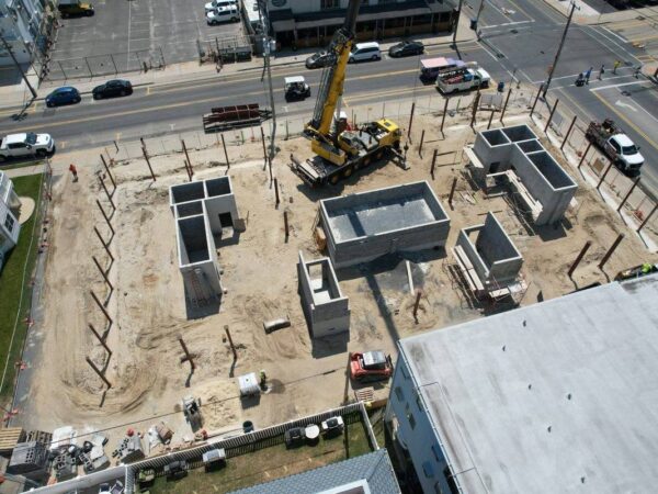 Aerial view of the Grove GMK4115 setting steel columns on a building foundation