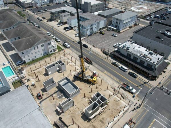 Aerial view of the Grove GMK4115 setting steel columns on a building foundation