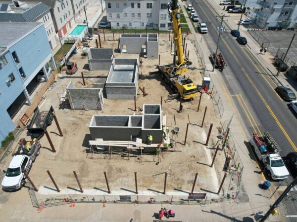 Aerial view of the Grove GMK4115 setting steel columns on a building foundation