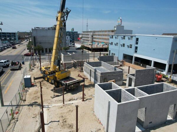 Aerial view of the Grove GMK4115 setting steel columns on a building foundation