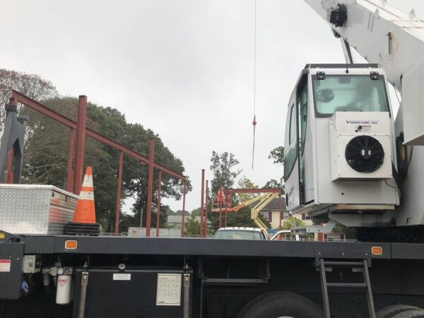 Manitex 40124SHL boom truck lifting steel on a commercial job