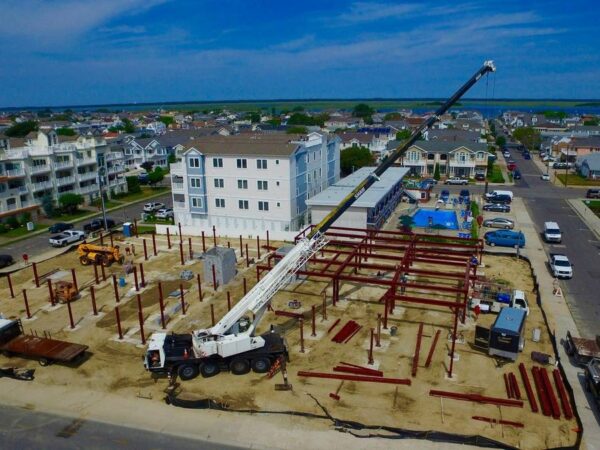 Manitex 40124SHL boom truck lifting steel on a commercial job