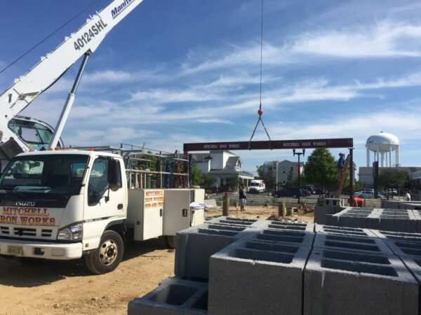 Manitex 40124SHL boom truck setting structural steel