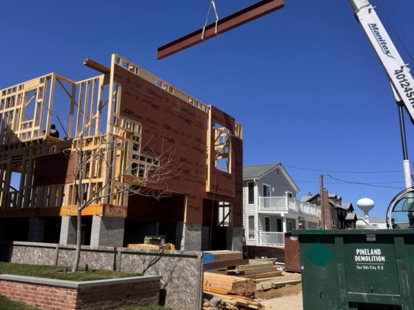 Manitex 40124SHL boom truck setting a steel frame on a shore home