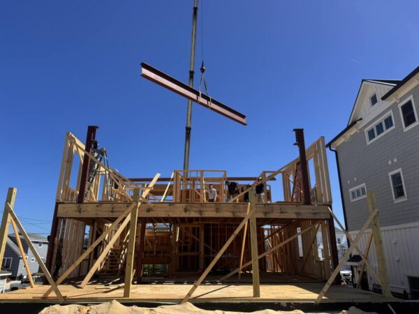 Manitex 40124SHL boom truck setting a steel frame on a shore home
