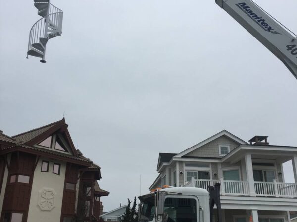 Manitex 40124SHL boom truck lifting a spiral staircase