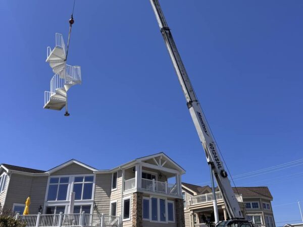 Manitex 40124SHL boom truck lifting a spiral staircase