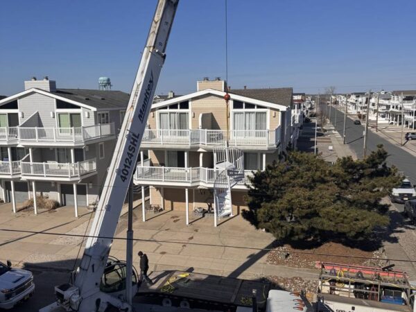 Manitex 40124SHL boom truck lifting a spiral staircase