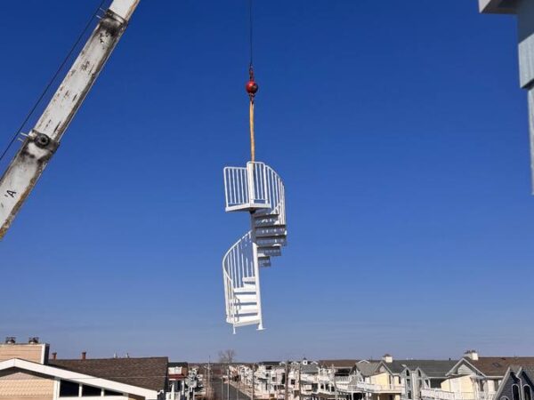 Manitex 40124SHL boom truck lifting a spiral staircase